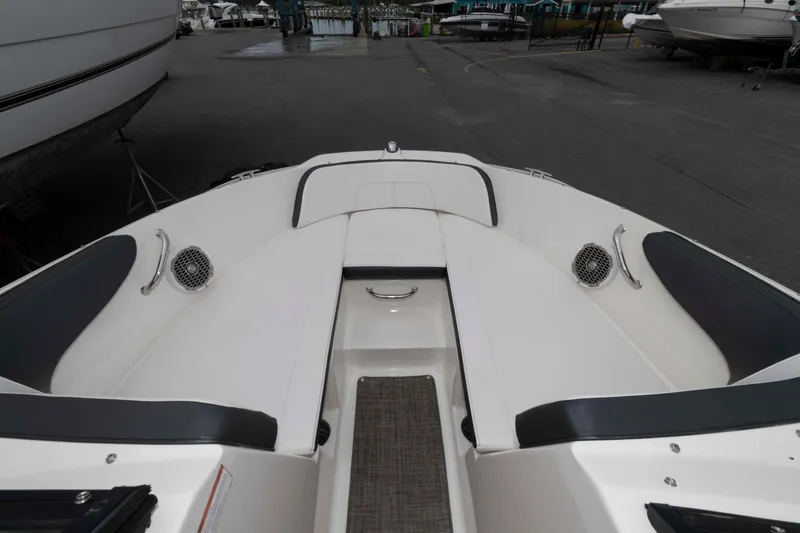 Slide: The Image of 2018 Sea Ray SPX 190 boat interior with white seating and speakers. - 9