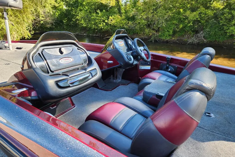 Slide: The Image of 2013 Triton 19XS boat interior with red and black seats, steering wheel, and dashboard. - 11