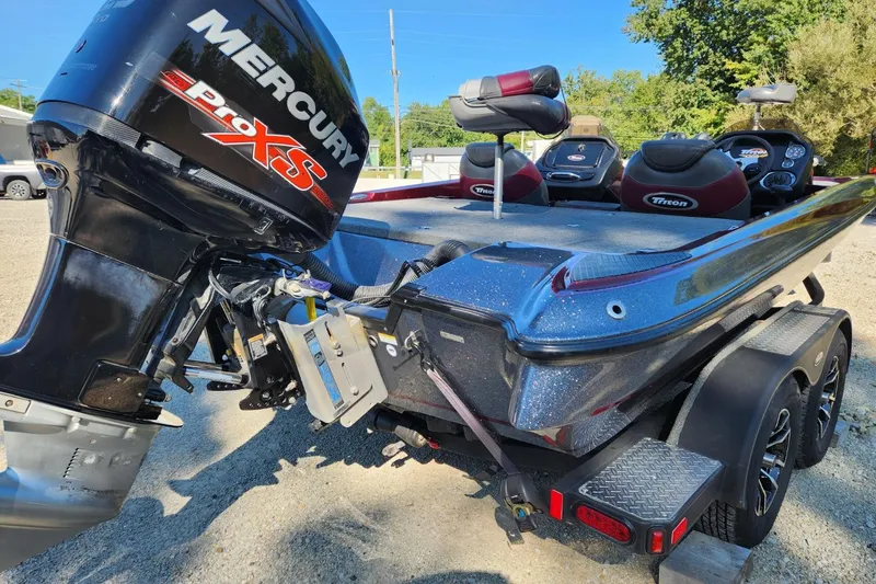 Slide: The Image of 2013 Triton 19XS boat with Mercury Pro XS engine, parked on a trailer. - 14