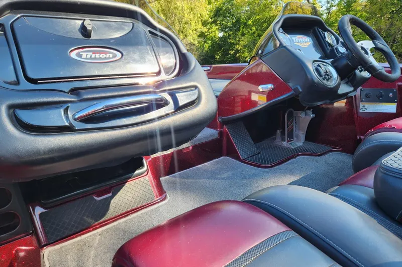 Slide: The Image of 2013 Triton 19XS boat interior with steering wheel and dashboard, featuring sleek design. - 17