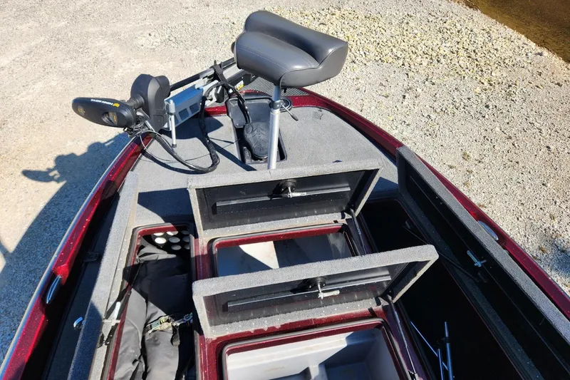 Slide: The Image of 2013 Triton 19XS boat interior with open storage compartments and seating. - 18