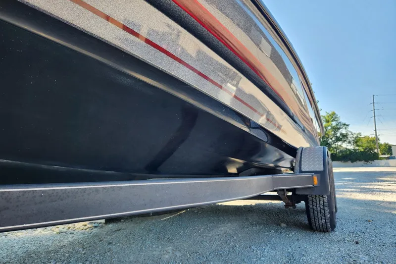 Slide: The Image of 2013 Triton 19XS boat on trailer, side view with sleek design and vibrant colors. - 21