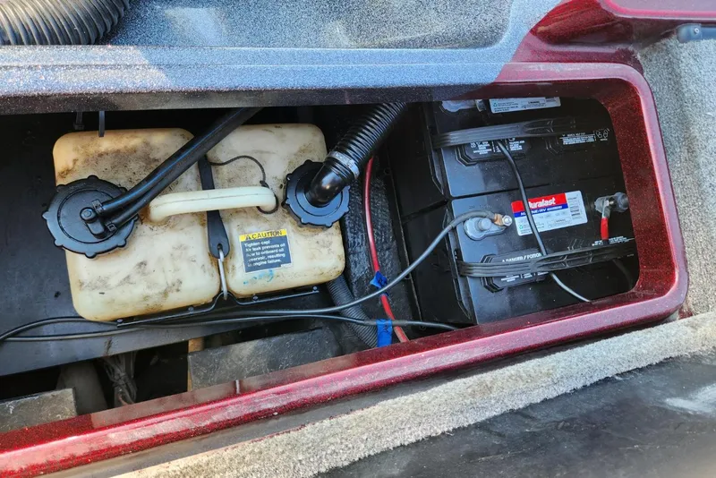 Slide: The Image of 2013 Triton 19XS boat battery compartment with dual batteries and fuel tank. - 24