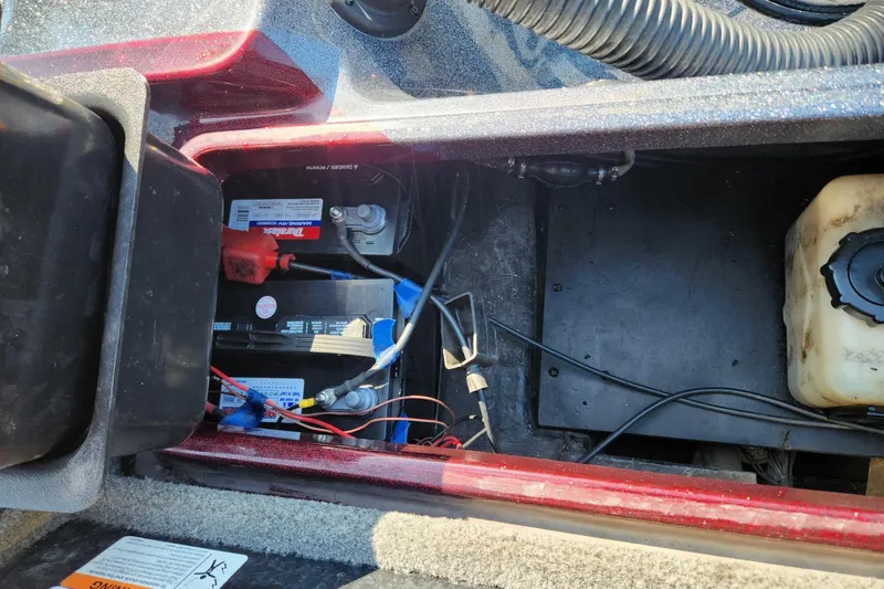 Slide: The Image of Battery compartment of a 2013 Triton 19XS boat, showing wiring and components. - 25