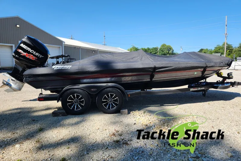 Slide: The Image of 2013 Triton 19XS boat with cover, on trailer, featuring Mercury Pro XS engine. - 26