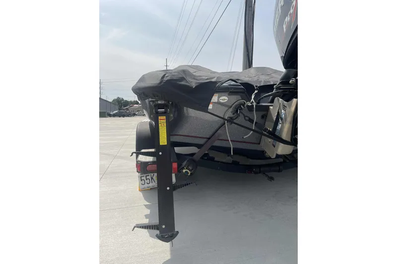 Slide: The Image of 2013 Triton 19XS boat with cover, parked on concrete, rear view. - 30