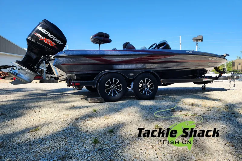 Slide: The Image of 2013 Triton 19XS boat with Mercury engine, parked outdoors at Tackle Shack. - 6