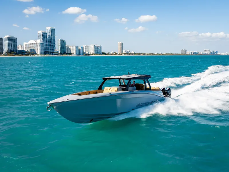 Slide: The Image of 2024 Concept 44' Open boat cruising on turquoise water near city skyline. - 3