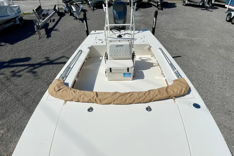 Slide: The Image of 2022 Hewes Redfisher 21 boat, white deck, center console, parked on gravel. - 13
