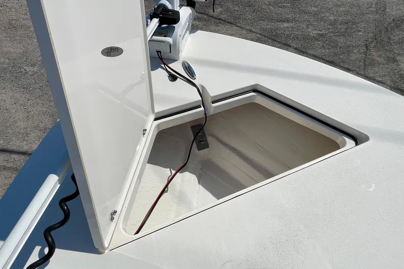 Slide: The Image of 2022 Hewes Redfisher 21 boat storage compartment with open hatch and wiring visible. - 15