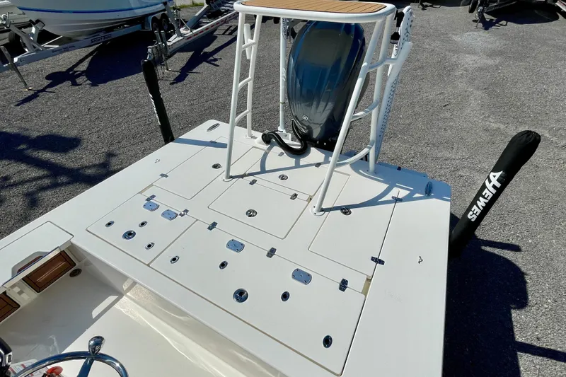 Slide: The Image of 2022 Hewes Redfisher 21 boat deck with motor and storage compartments. - 20