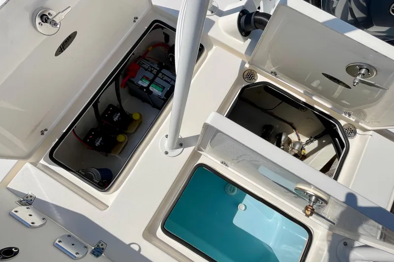 Slide: The Image of 2022 Hewes Redfisher 21 boat compartments with battery and storage areas open. - 23