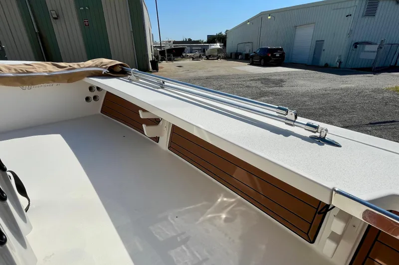 Slide: The Image of 2022 Hewes Redfisher 21 boat interior with rod holders and storage compartments. - 25
