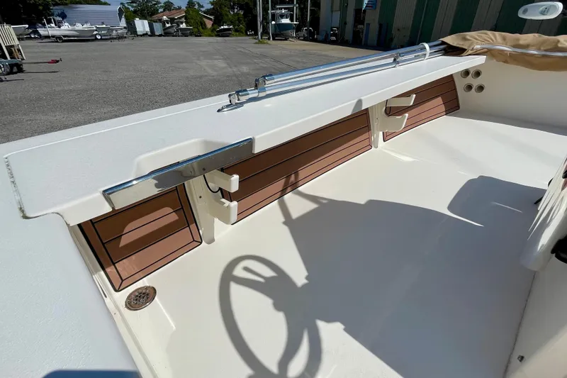 Slide: The Image of 2022 Hewes Redfisher 21 boat interior with rod holders and storage compartments. - 26