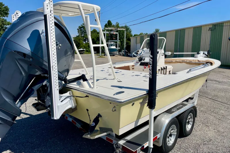 Slide: The Image of 2022 Hewes Redfisher 21 boat on trailer, featuring powerful outboard motor. - 3