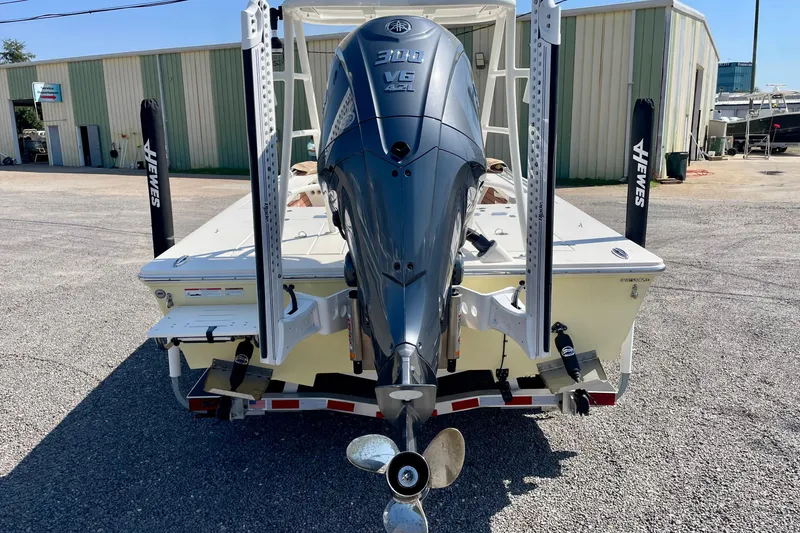 Slide: The Image of 2022 Hewes Redfisher 21 boat with powerful 300 V6 engine, parked outdoors. - 5