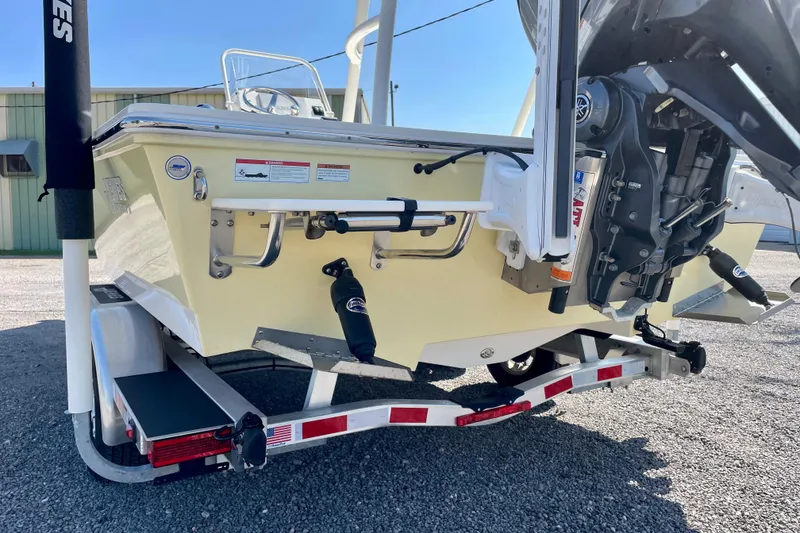 Slide: The Image of 2022 Hewes Redfisher 21 boat on trailer, rear view with motor and equipment. - 6