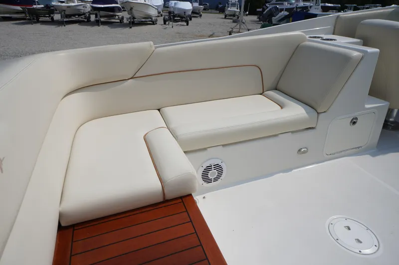 Slide: The Image of 2007 Chris-Craft Corsair 28 boat interior with cream leather seating and wooden flooring. - 10