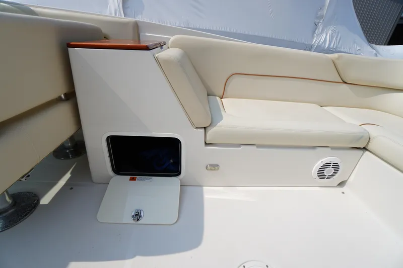 Slide: The Image of 2007 Chris-Craft Corsair 28 interior with beige seating and storage compartment. - 12