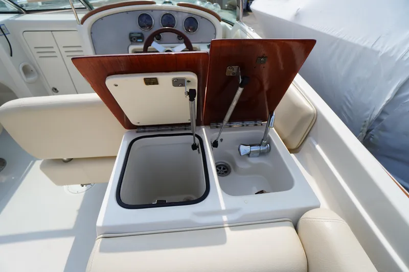 Slide: The Image of 2007 Chris-Craft Corsair 28 boat interior with open storage and sink. - 14