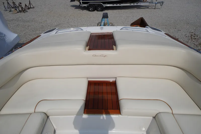 Slide: The Image of 2007 Chris-Craft Corsair 28 boat interior with cream leather seating and wooden accents. - 15