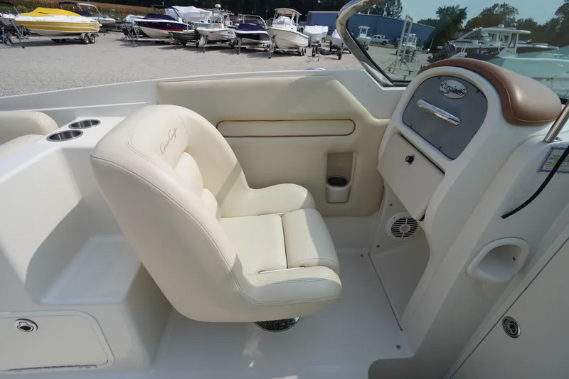 Slide: The Image of 2007 Chris-Craft Corsair 28 boat interior with cream leather seating and dashboard. - 18