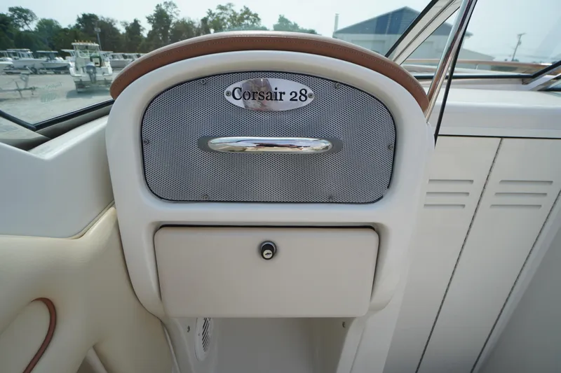Slide: The Image of 2007 Chris-Craft Corsair 28 dashboard with storage compartment and sleek design. - 20