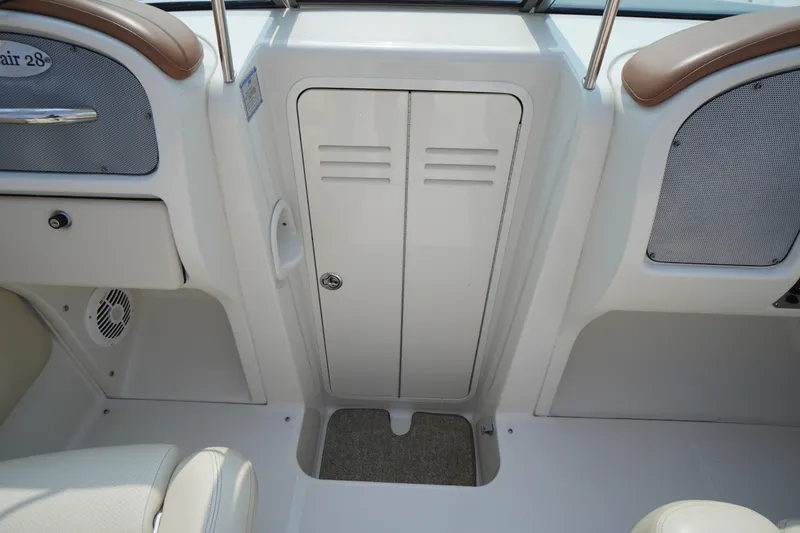Slide: The Image of 2007 Chris-Craft Corsair 28 interior, featuring sleek design and storage compartment. - 23