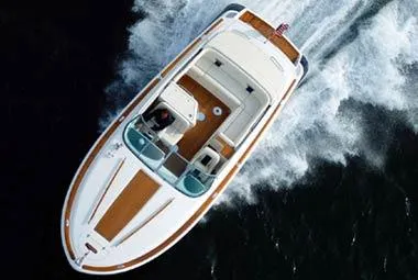 Slide: The Image of 2007 Chris-Craft Corsair 28 boat interior with beige seating and wooden accents. - 29