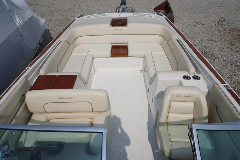 Slide: The Image of 2007 Chris-Craft Corsair 28 boat interior with cream leather seating and wood accents. - 4