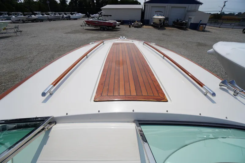 Slide: The Image of 2007 Chris-Craft Corsair 28 boat with wooden deck detail in a marina setting. - 5