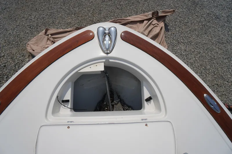 Slide: The Image of 2007 Chris-Craft Corsair 28 boat bow with anchor compartment and wooden trim. - 8