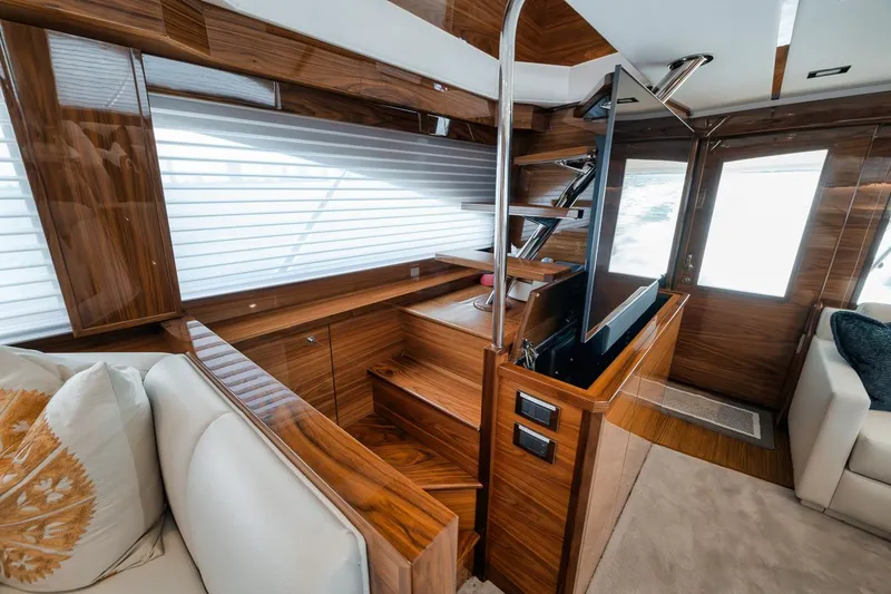 Slide: The Image of Luxurious interior of 2024 Viking 72 Skybridge yacht with modern wood finishes and sleek design. - 14