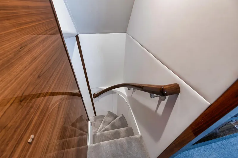 Slide: The Image of Elegant staircase in 2024 Viking 72 Skybridge yacht with wooden handrail and plush carpet. - 15