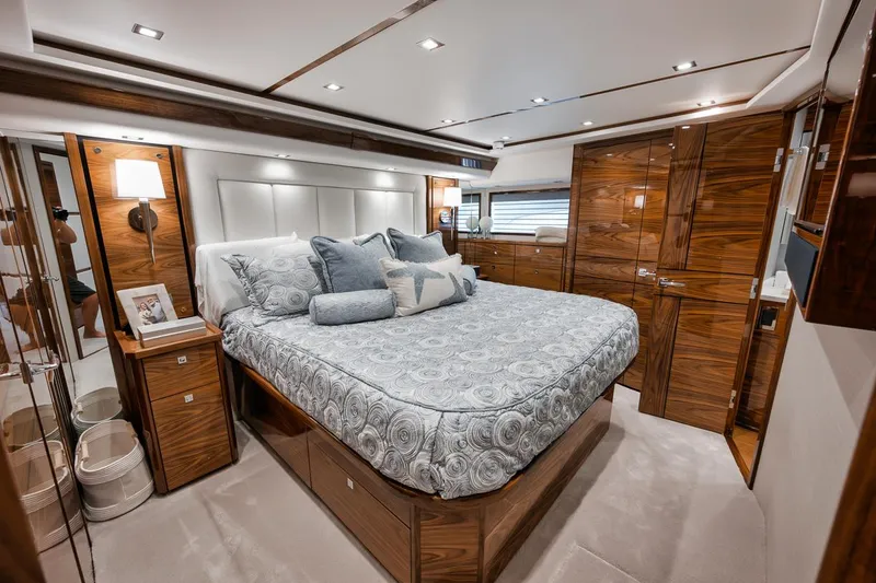 Slide: The Image of Luxurious bedroom interior of 2024 Viking 72 Skybridge yacht with elegant wood finishes. - 16