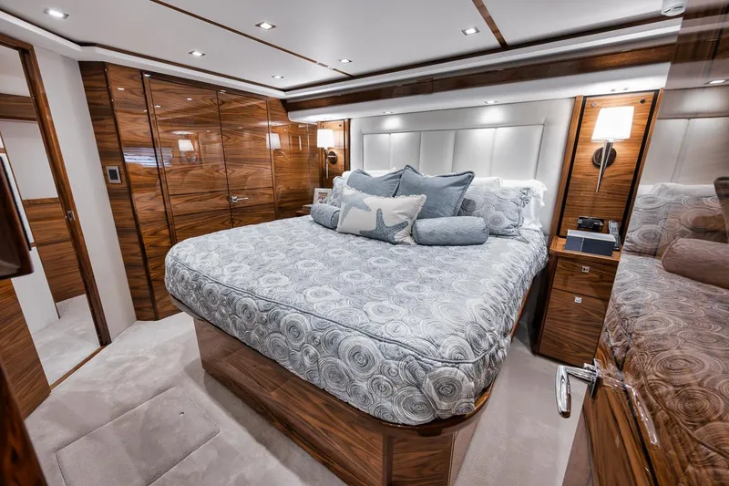 Slide: The Image of Luxurious bedroom interior of 2024 Viking 72 Skybridge yacht with elegant wood finishes. - 18
