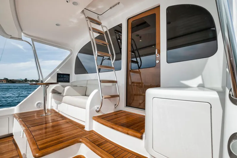 Slide: The Image of 2024 Viking 72 Skybridge yacht with teak deck and sleek interior design. - 2