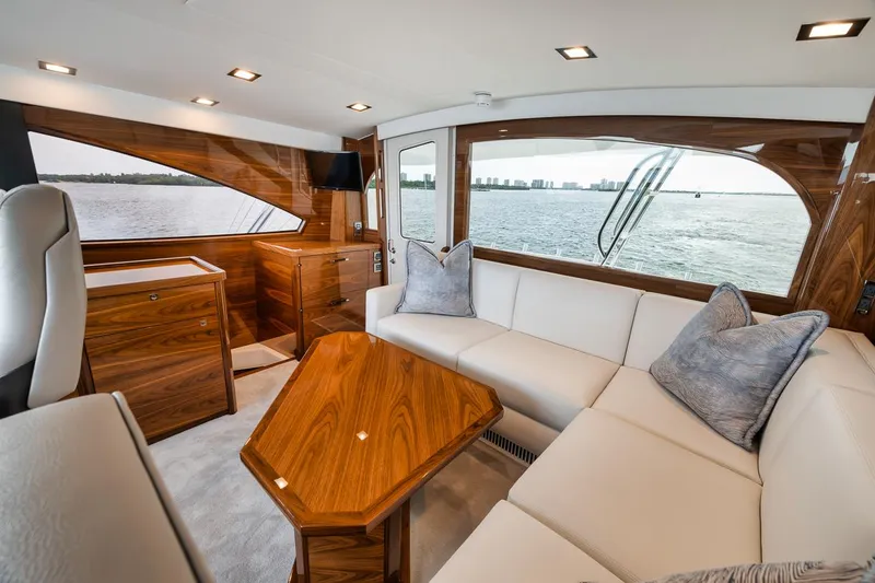 Slide: The Image of Luxurious interior of 2024 Viking 72 Skybridge yacht with elegant wood finishes and waterfront view. - 28