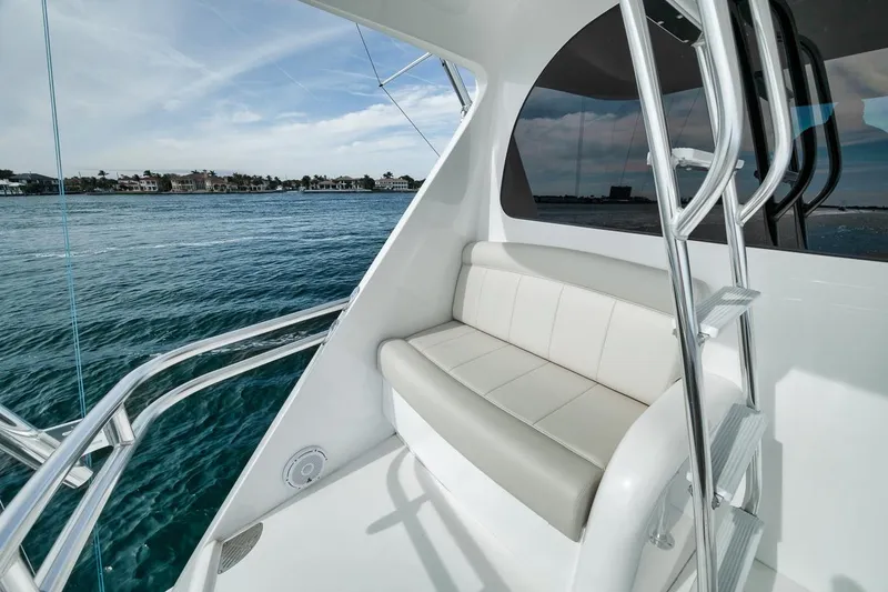 Slide: The Image of 2024 Viking 72 Skybridge yacht with sleek seating and ocean view. - 32