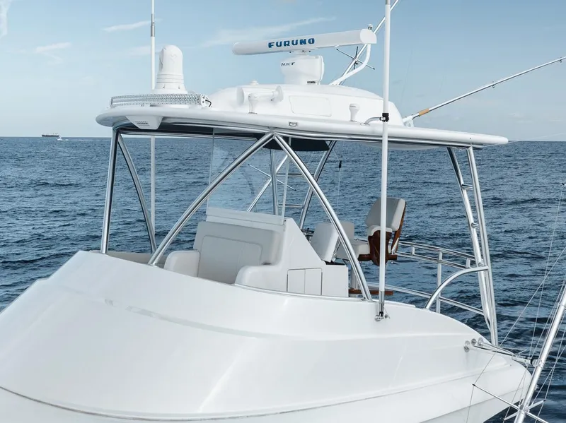 Slide: The Image of 2024 Viking 72 Skybridge yacht on open sea, featuring advanced navigation equipment. - 35