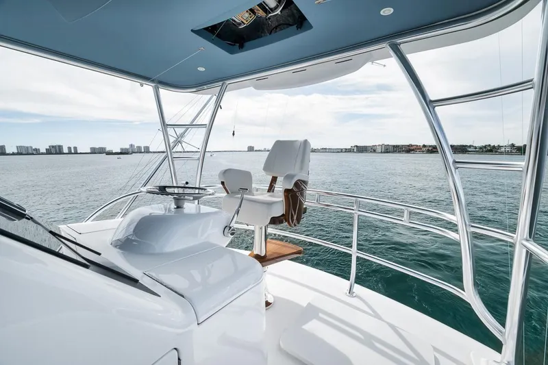 Slide: The Image of 2024 Viking 72 Skybridge yacht helm overlooking ocean view. - 42