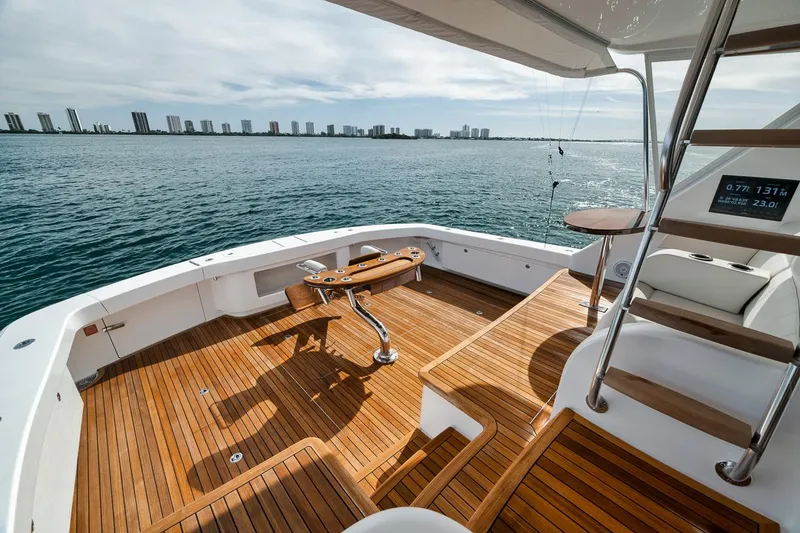 Slide: The Image of Luxurious 2024 Viking 72 Skybridge yacht deck with ocean view and wooden flooring. - 45