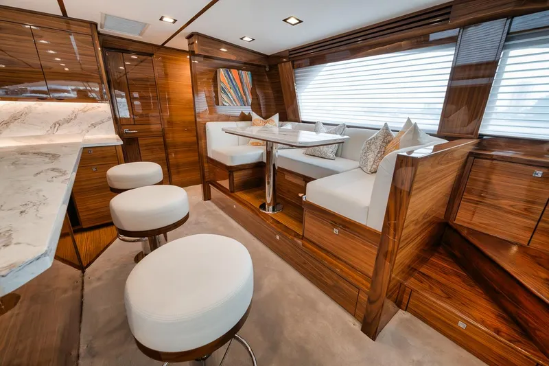 Slide: The Image of Luxurious interior of 2024 Viking 72 Skybridge yacht with elegant wood finishes and plush seating. - 7