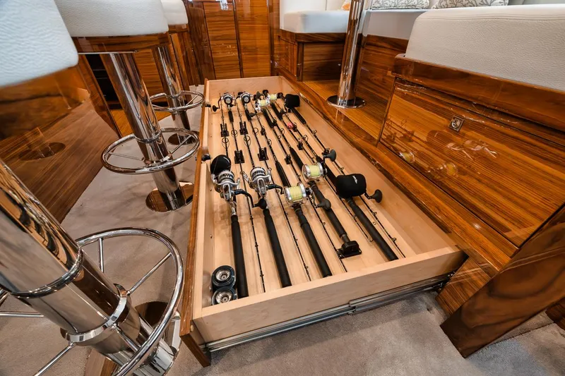 Slide: The Image of Fishing rod storage in 2024 Viking 72 Skybridge yacht interior, featuring sleek wooden cabinetry. - 8
