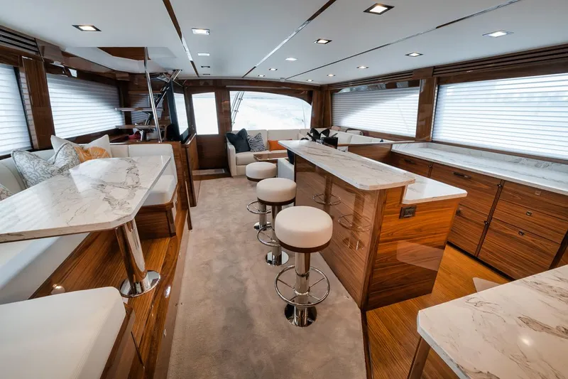 Slide: The Image of Luxurious interior of 2024 Viking 72 Skybridge yacht with elegant seating and marble countertops. - 9