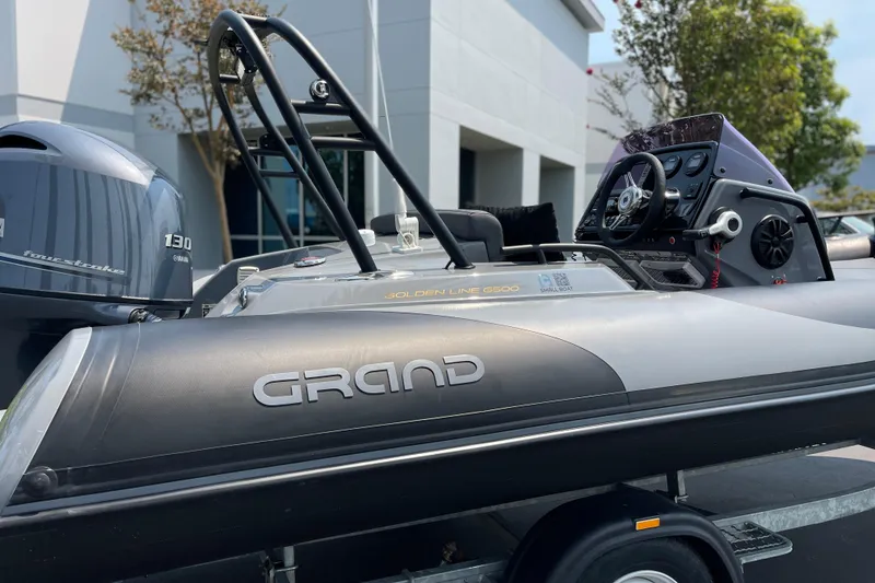 Slide: The Image of 2017 Grand Goldenline 500 boat with Yamaha 130 engine, parked outdoors. - 10