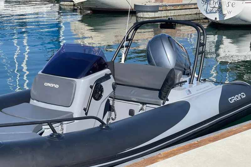 Slide: The Image of 2017 Grand Goldenline 500 boat docked in marina, sleek design, calm water reflections. - 17