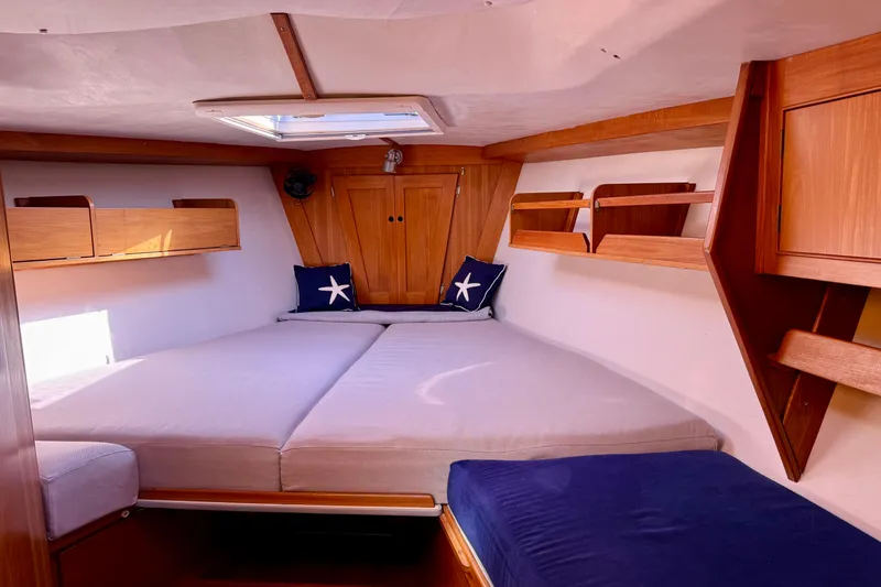 Slide: The Image of Cozy cabin interior of a 1991 J/Boats model, featuring wooden accents and nautical decor. - 11