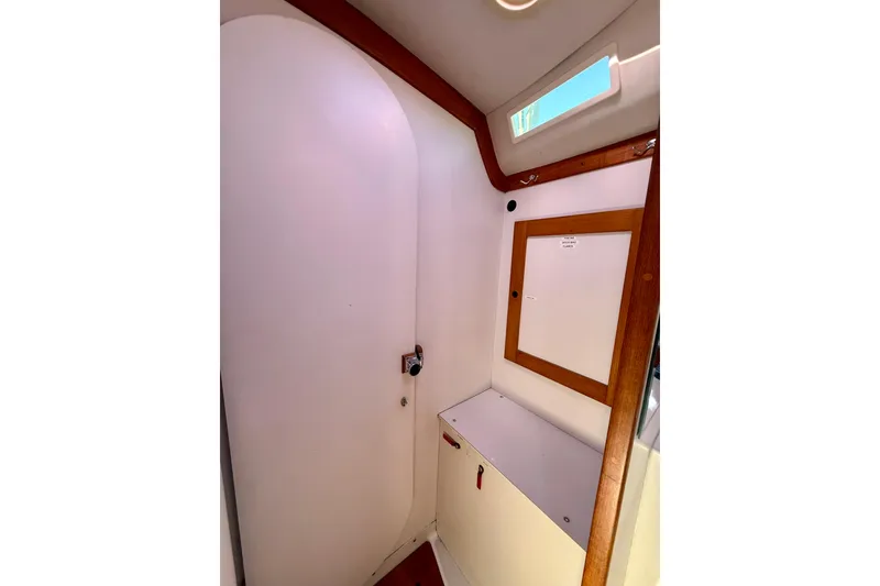 Slide: The Image of Interior of 1991 J/Boats model, featuring wooden trim and storage compartment. - 19