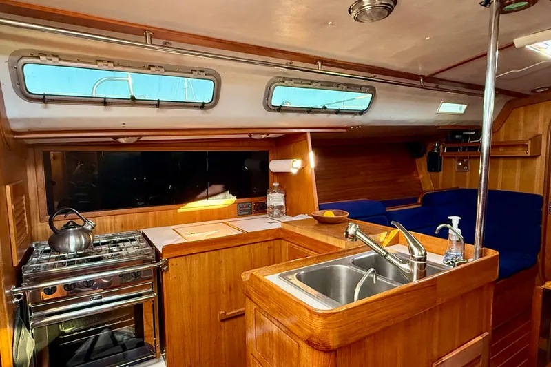 Slide: The Image of Interior of 1991 J/Boats yacht with wooden cabinetry and modern kitchen amenities. - 8